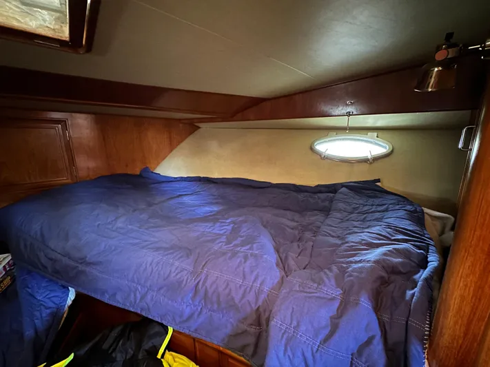  Yacht Photos Pics Cozy cabin interior of 1987 Ocean Alexander 46 Cockpit Motor Yacht with blue bedding.