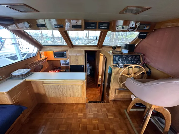  Yacht Photos Pics 1987 Ocean Alexander 46 Cockpit Motor Yacht interior with helm, wooden cabinetry, and navigation equipment.