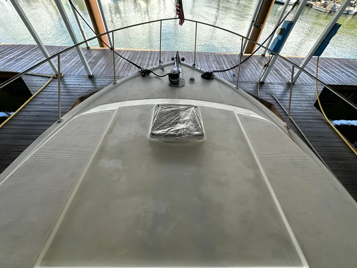  Yacht Photos Pics 1987 Ocean Alexander 46 Cockpit Motor Yacht, docked with a view of the bow and water.