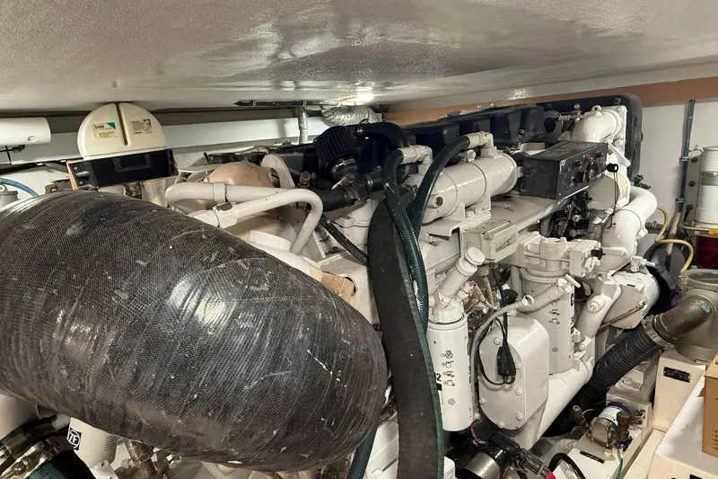 One Life Yacht Photos Pics Engine room of a 2000 Hatteras 50 Convertible yacht, showcasing complex machinery.