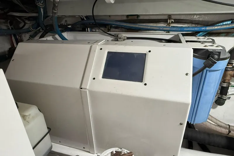 One Life Yacht Photos Pics Engine room of 2000 Hatteras 50 Convertible yacht, featuring mechanical components and wiring.