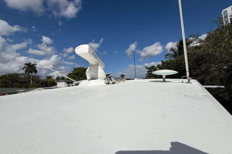 One Life Yacht Photos Pics Rooftop view of 2000 Hatteras 50 Convertible yacht under a clear blue sky.