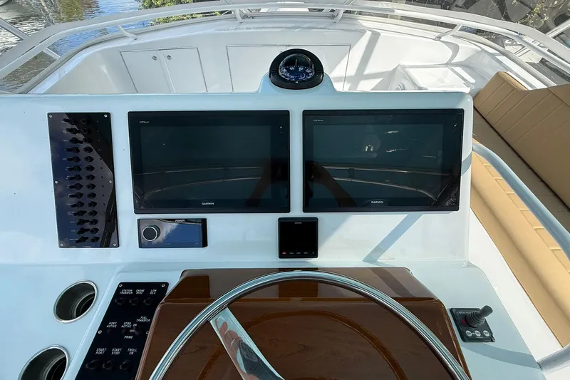 One Life Yacht Photos Pics Helm of 2000 Hatteras 50 Convertible with dual Garmin displays and compass.