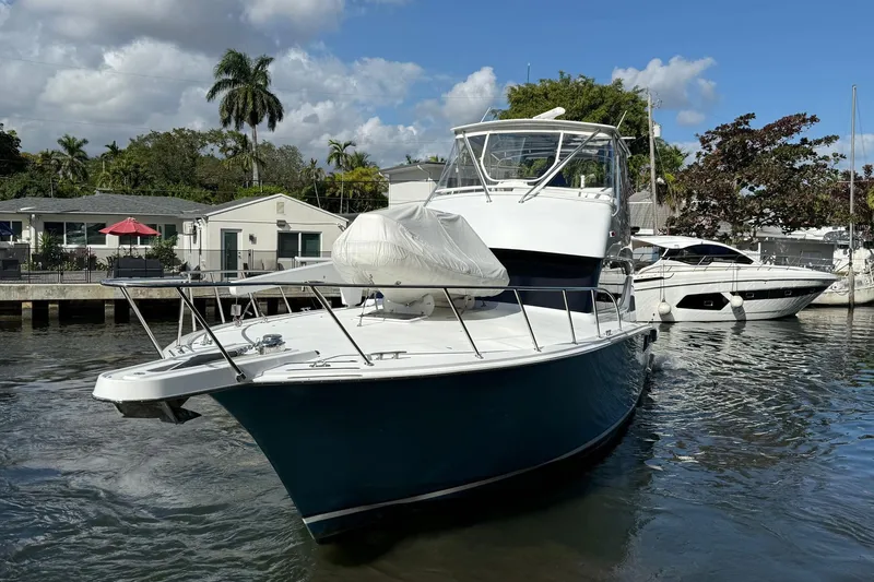 One Life Yacht Photos Pics 2000 Hatteras 50 Convertible yacht docked in a sunny marina setting.