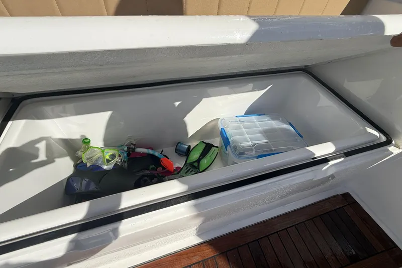 One Life Yacht Photos Pics Storage compartment on 2000 Hatteras 50 Convertible with snorkeling gear and tackle box.