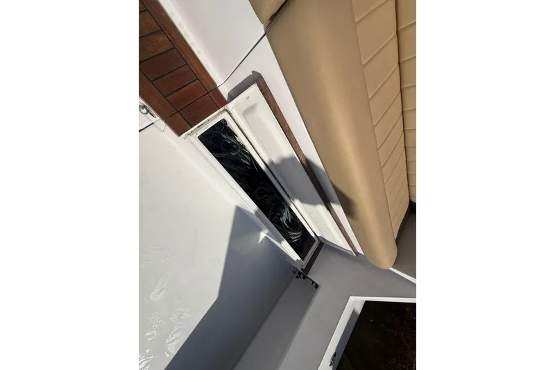 One Life Yacht Photos Pics 2000 Hatteras 50 Convertible boat deck with beige seating and storage compartment.