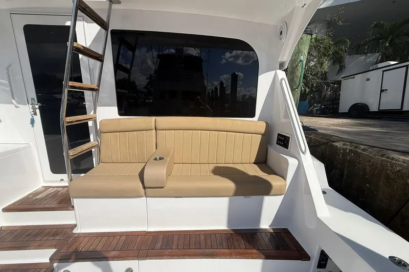 One Life Yacht Photos Pics 2000 Hatteras 50 Convertible yacht with tan seating and wooden steps.