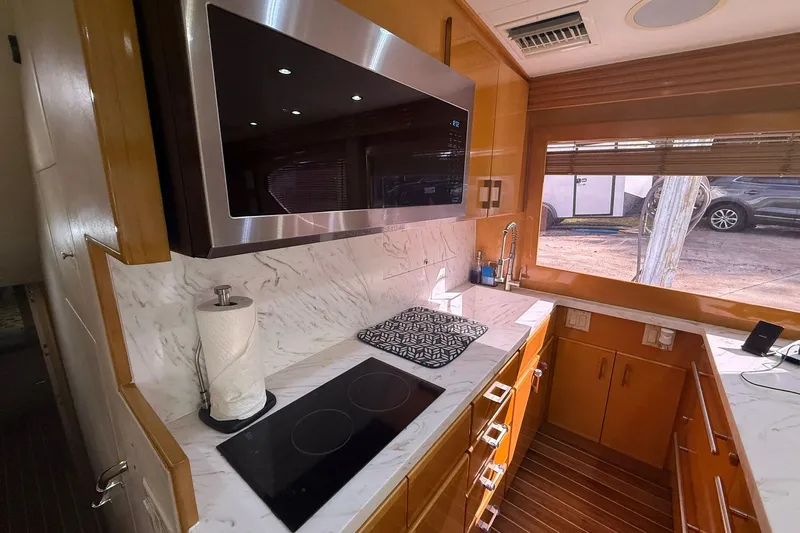 One Life Yacht Photos Pics Luxurious kitchen interior of 2000 Hatteras 50 Convertible yacht with modern appliances.