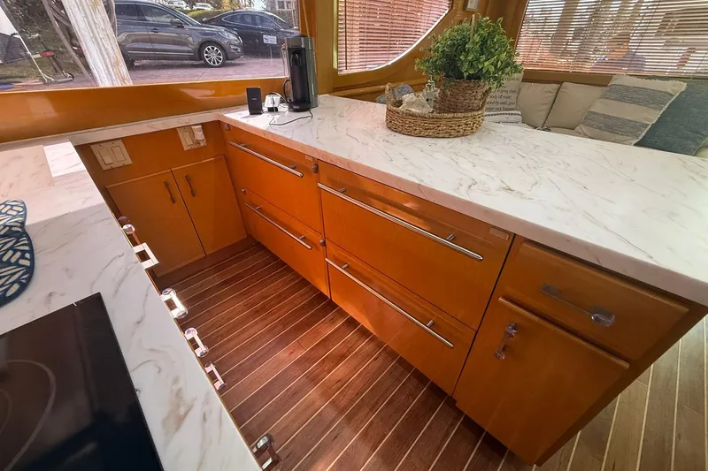One Life Yacht Photos Pics Luxurious kitchen interior of 2000 Hatteras 50 Convertible yacht with marble countertops.