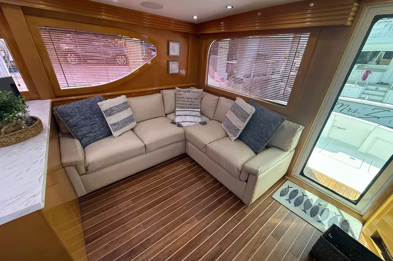 One Life Yacht Photos Pics Luxurious interior of 2000 Hatteras 50 Convertible yacht with cozy seating and elegant decor.