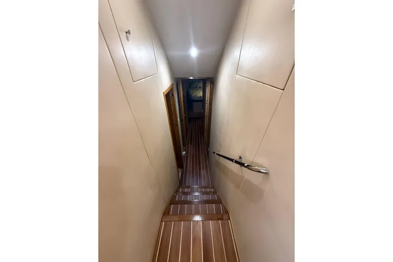 One Life Yacht Photos Pics Narrow hallway with wooden flooring inside 2000 Hatteras 50 Convertible yacht.