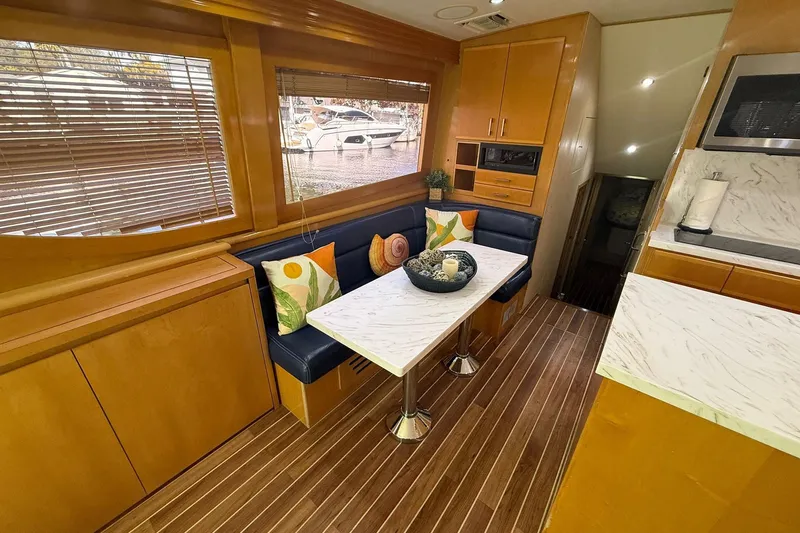 One Life Yacht Photos Pics Luxurious interior of 2000 Hatteras 50 Convertible yacht with elegant dining area.