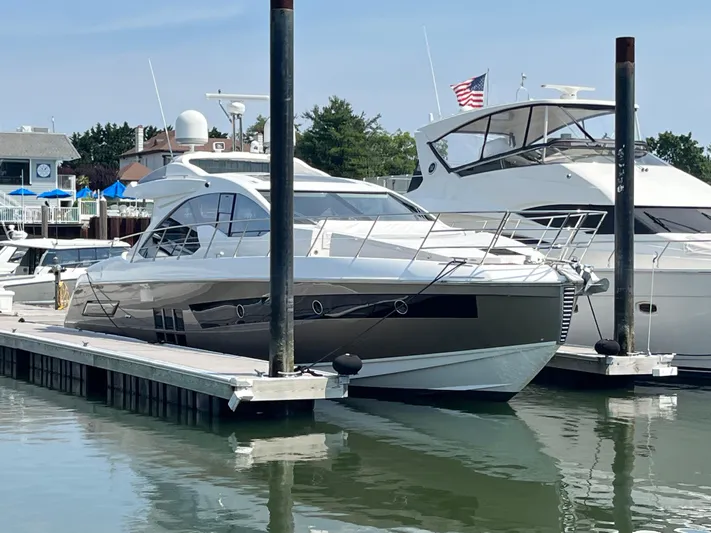 Penny Lane Yacht Photos Pics 2014 Azimut 55S yacht docked at marina, clear sky, American flag visible.