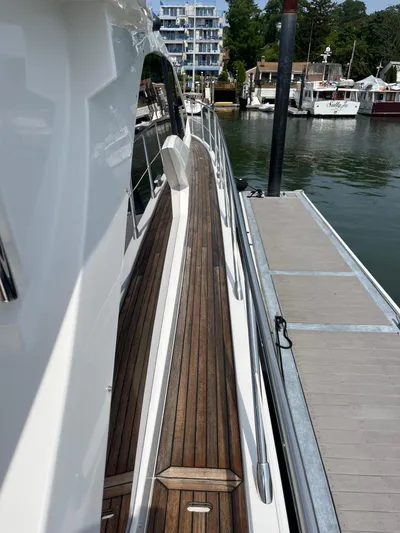 Penny Lane Yacht Photos Pics 2014 Azimut 55S yacht docked, showcasing sleek design and wooden deck.