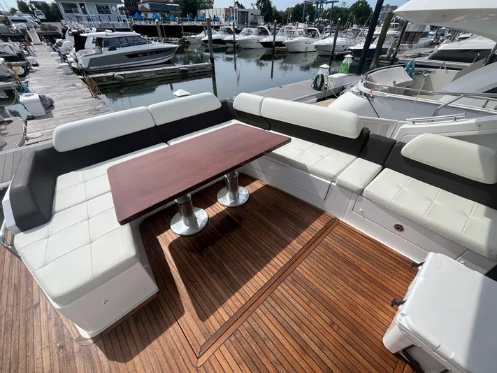 Penny Lane Yacht Photos Pics Luxurious 2014 Azimut 55S yacht deck with elegant seating and wooden table at marina.