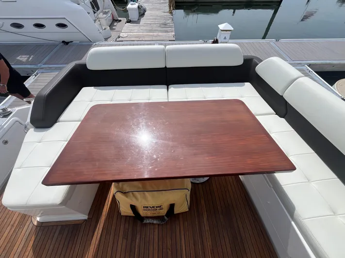 Penny Lane Yacht Photos Pics Luxurious seating area on a 2014 Azimut 55S yacht with wooden table and cushioned seats.