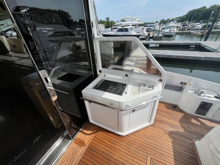 Penny Lane Yacht Photos Pics Outdoor kitchen on 2014 Azimut 55S yacht with grill and sink, docked at marina.