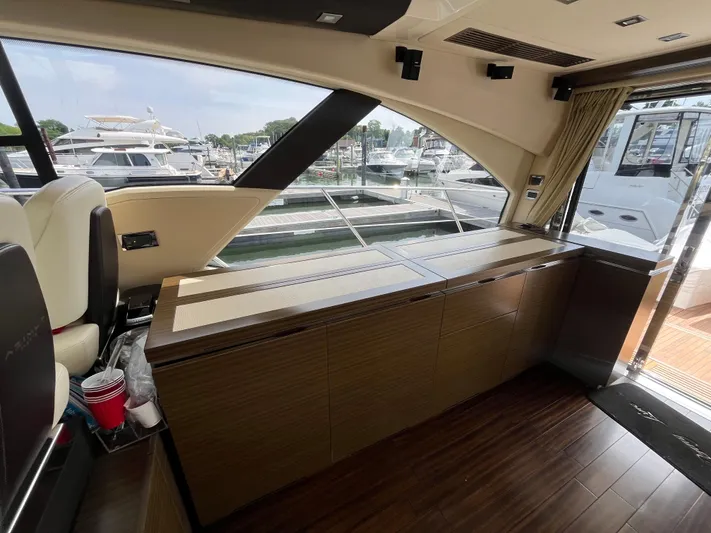Penny Lane Yacht Photos Pics Interior of 2014 Azimut 55S yacht with wooden cabinetry and marina view.