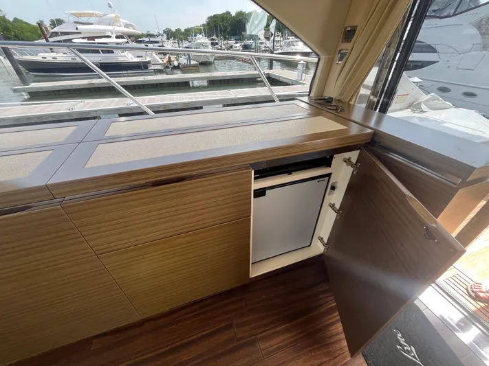Penny Lane Yacht Photos Pics Interior of 2014 Azimut 55S yacht with open cabinet and mini fridge.