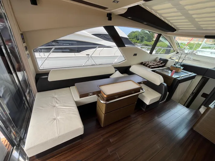 Penny Lane Yacht Photos Pics Luxurious interior of a 2014 Azimut 55S yacht with elegant seating and wooden flooring.