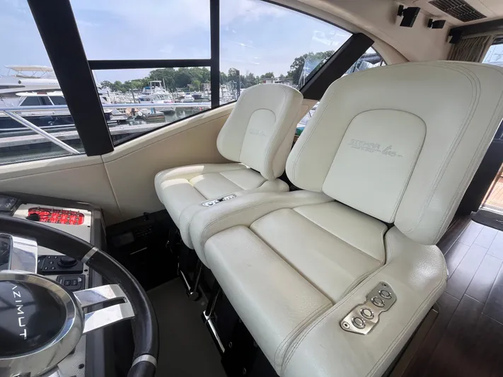 Penny Lane Yacht Photos Pics Luxurious interior of a 2014 Azimut 55S yacht with plush white seating.