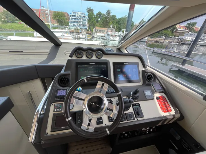 Penny Lane Yacht Photos Pics Cockpit of 2014 Azimut 55S yacht with advanced navigation controls and steering wheel.