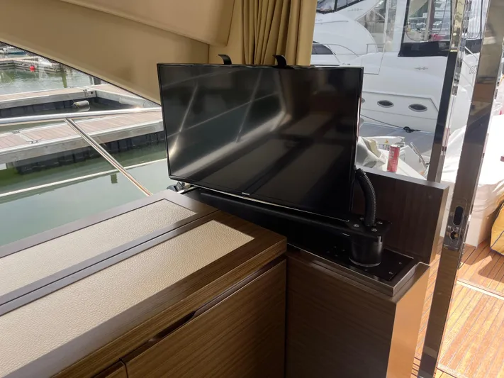 Penny Lane Yacht Photos Pics Luxurious interior of 2014 Azimut 55S yacht with modern TV setup.