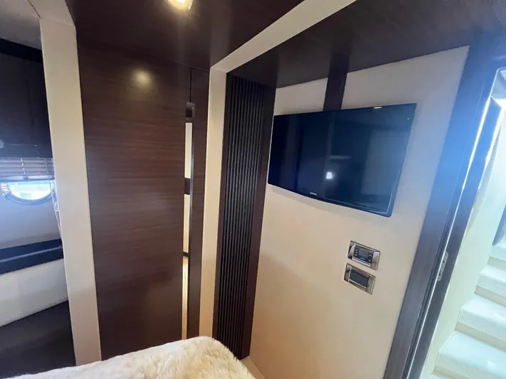 Penny Lane Yacht Photos Pics Luxurious interior of 2014 Azimut 55S yacht with modern TV and elegant wood paneling.