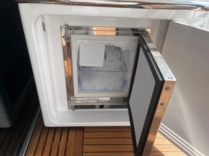 Penny Lane Yacht Photos Pics Ice maker on 2014 Azimut 55S yacht with open door, showing ice cubes inside.