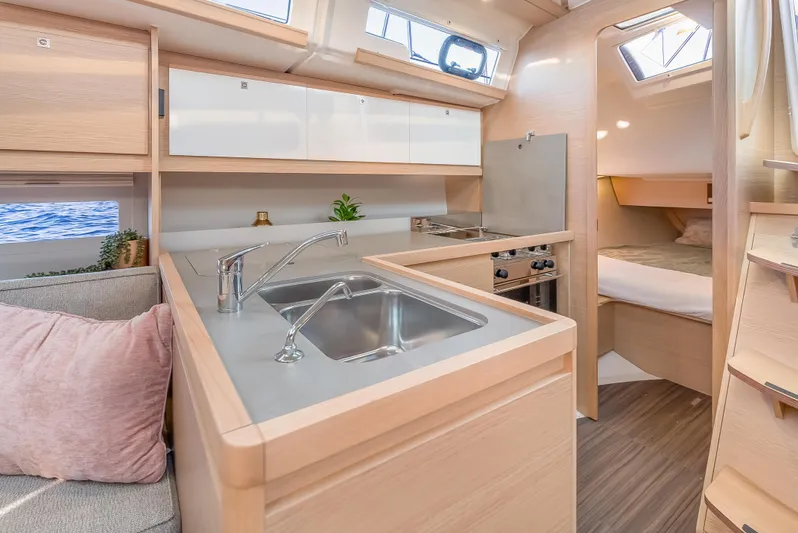 In Stock #325 Yacht Photos Pics Modern kitchen interior of 2023 Dufour 390 yacht with sleek design and ample natural light.