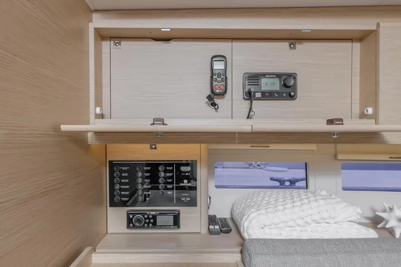 In Stock #325 Yacht Photos Pics Interior of 2023 Dufour 390 yacht with navigation equipment and cozy bedding.