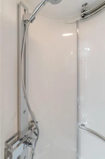 Tranquility Yacht Photos Pics Shower area in 2012 Sunseeker Portofino 48 yacht, featuring sleek chrome fixtures.