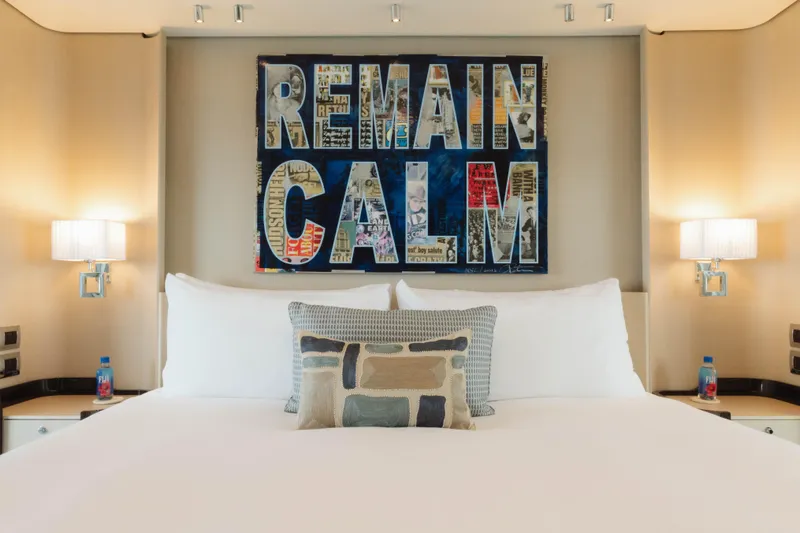 Carpe Diem Yacht Photos Pics Luxurious bedroom on 2023 Azimut 32M Grande yacht with "Remain Calm" artwork.