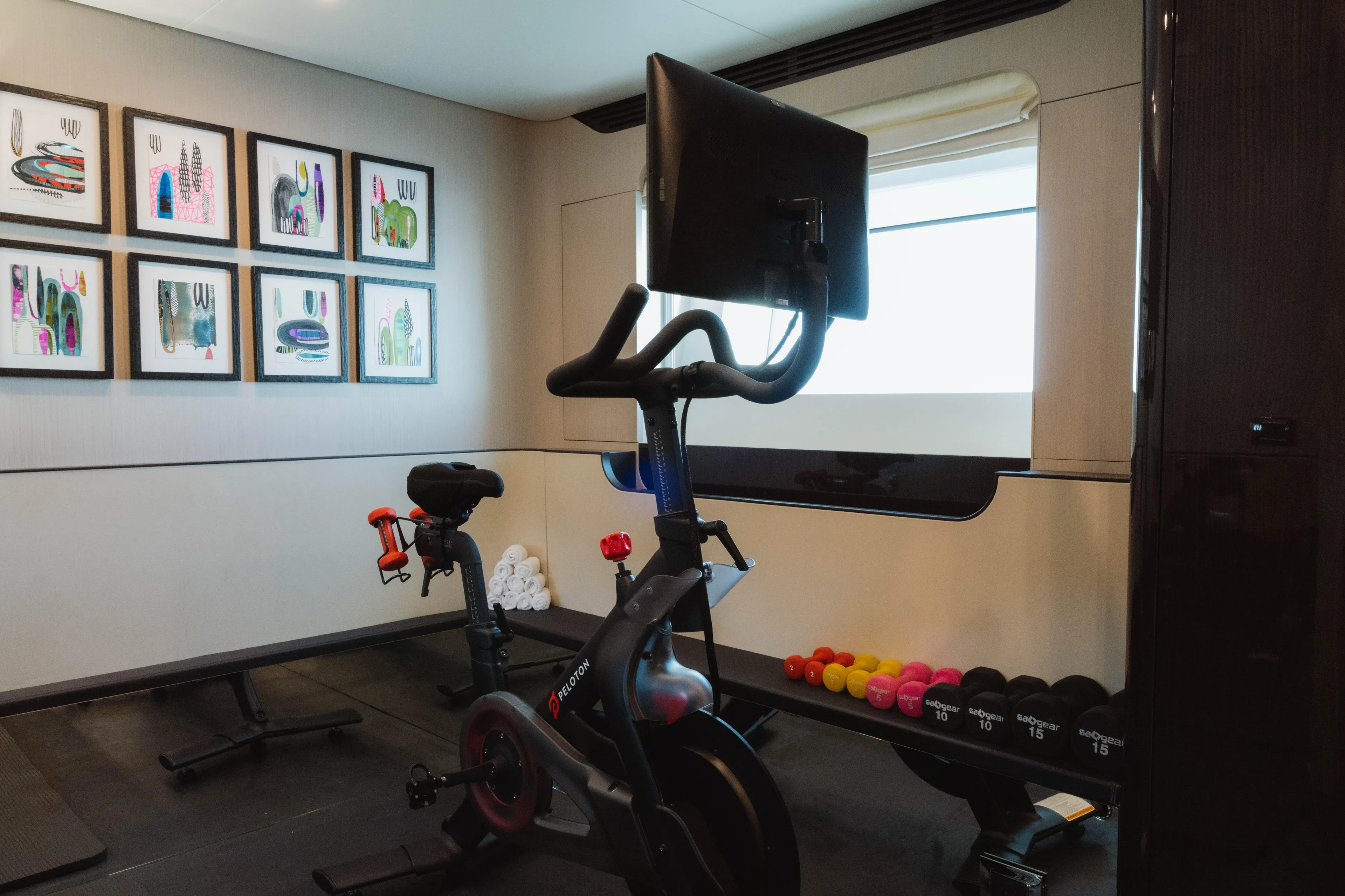 Carpe Diem Yacht Photos Pics Home gym on 2023 Azimut 32M Grande yacht with Peloton bike and weights.