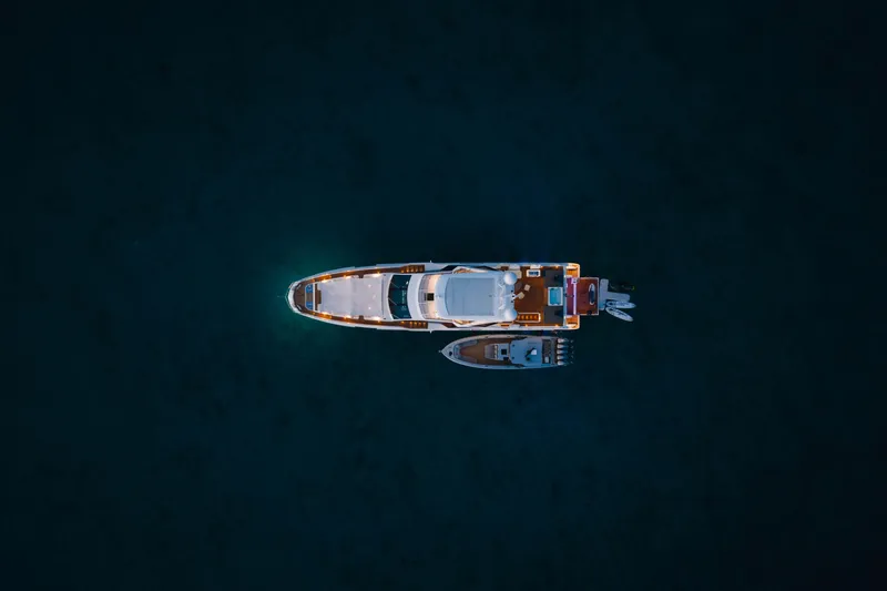 Carpe Diem Yacht Photos Pics Aerial view of 2023 Azimut yacht on dark water, illuminated at night.