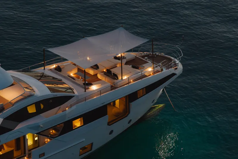 Carpe Diem Yacht Photos Pics Luxurious 2023 Azimut yacht illuminated at dusk, anchored on serene waters.