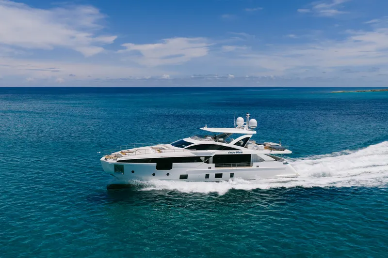 Carpe Diem Yacht Photos Pics Luxurious 2023 Azimut yacht cruising on clear blue ocean under a sunny sky.