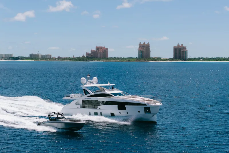 Carpe Diem Yacht Photos Pics 2023 Azimut yacht cruising near a coastal city skyline.