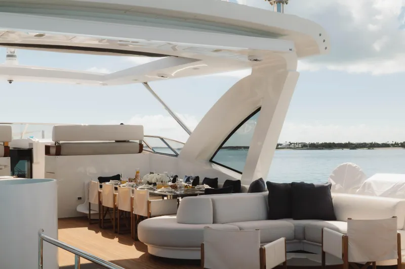 Carpe Diem Yacht Photos Pics Luxurious 2023 Azimut yacht deck with elegant dining area and ocean view.