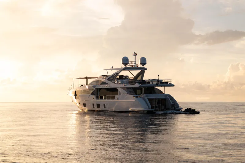 Carpe Diem Yacht Photos Pics Luxurious 2023 Azimut yacht cruising at sunset on calm ocean waters.