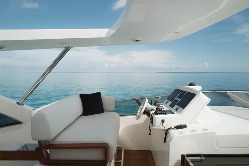 Carpe Diem Yacht Photos Pics Luxurious 2023 Azimut yacht helm with ocean view, featuring modern controls and seating.