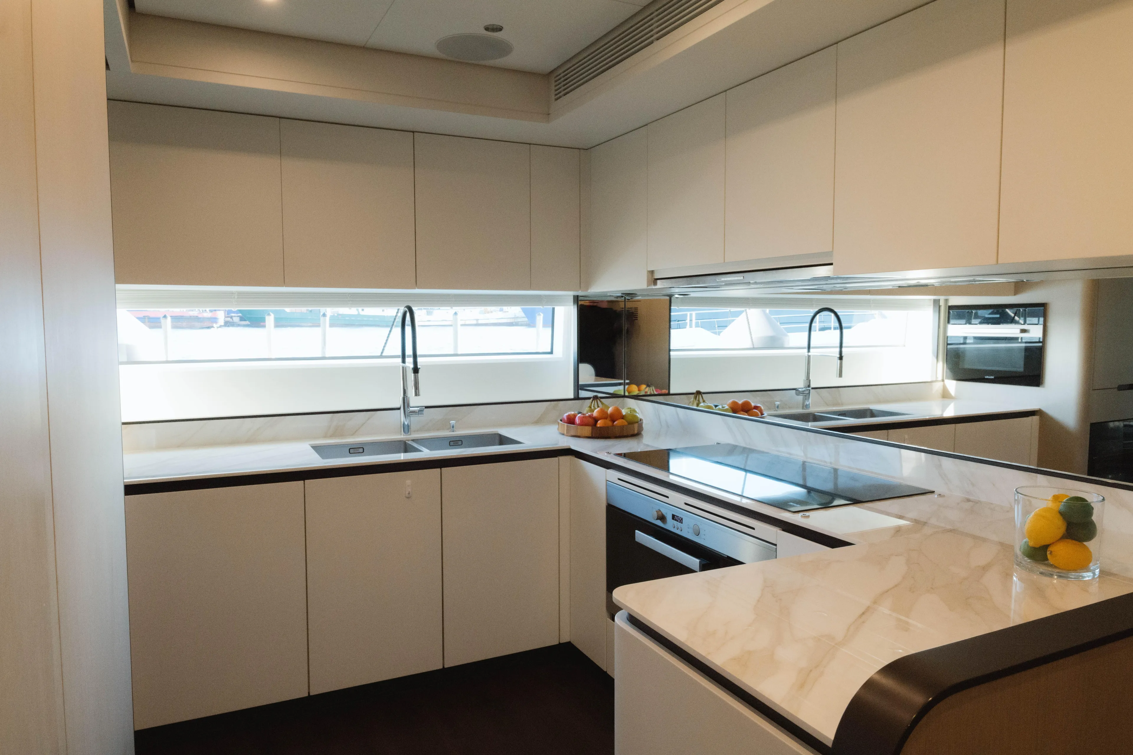 Carpe Diem Yacht Photos Pics Modern kitchen interior on 2023 Azimut yacht with sleek countertops and dual sinks.
