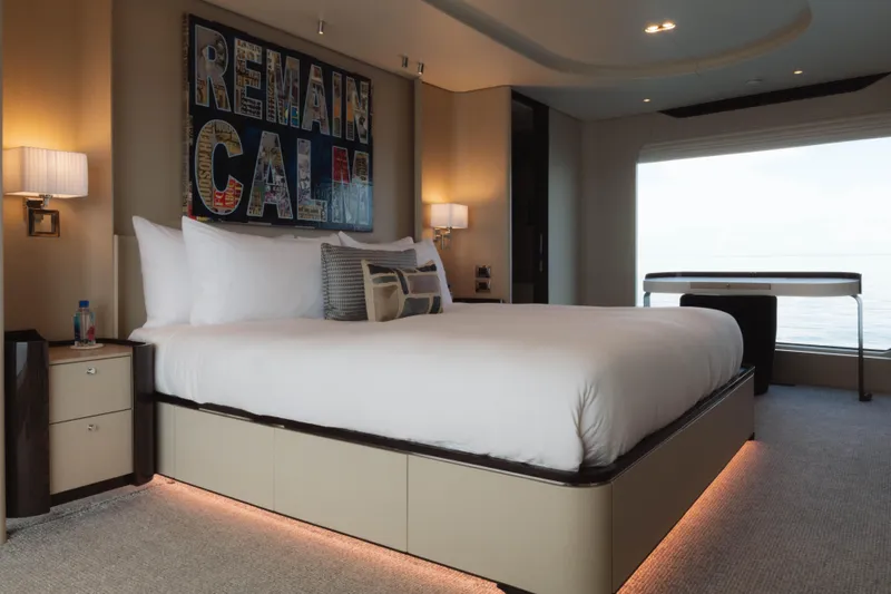 Carpe Diem Yacht Photos Pics Luxurious Azimut yacht bedroom with modern decor, large bed, and ocean view.
