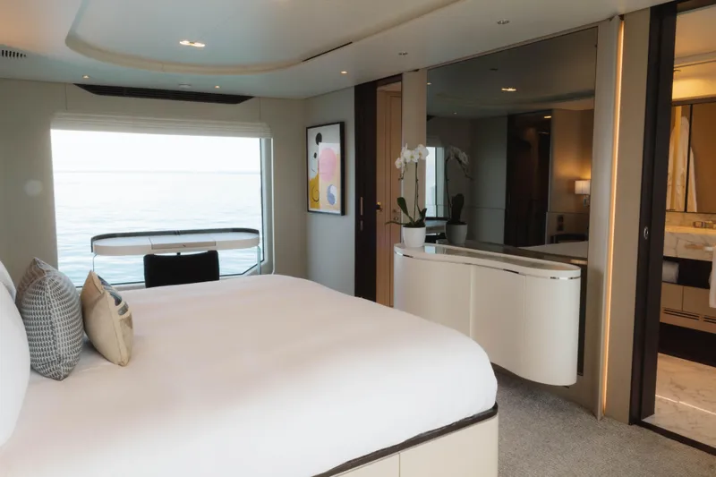 Carpe Diem Yacht Photos Pics Luxurious 2023 Azimut yacht bedroom with ocean view, modern decor, and elegant furnishings.