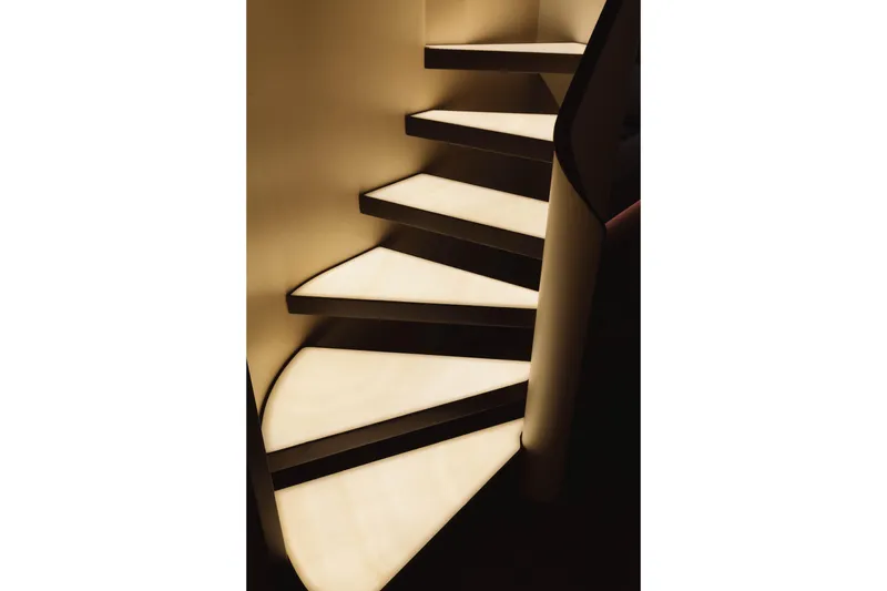Carpe Diem Yacht Photos Pics Illuminated spiral staircase on a 2023 Azimut yacht, showcasing modern design.