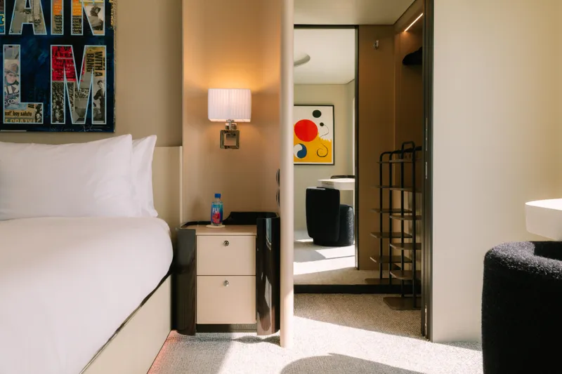 Carpe Diem Yacht Photos Pics Modern hotel room with stylish decor, abstract art, and cozy lighting, featuring Azimut design elements.