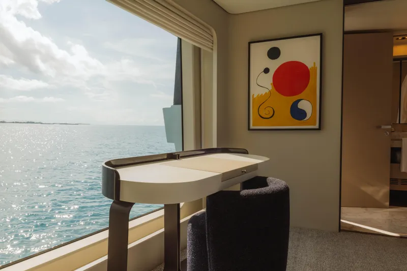Carpe Diem Yacht Photos Pics Luxurious Azimut yacht interior with ocean view, modern desk, and abstract art, 2023 model.