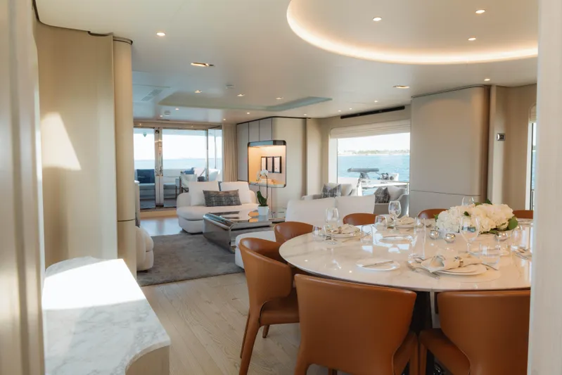 Carpe Diem Yacht Photos Pics Luxurious 2023 Azimut yacht interior with elegant dining area and scenic ocean view.