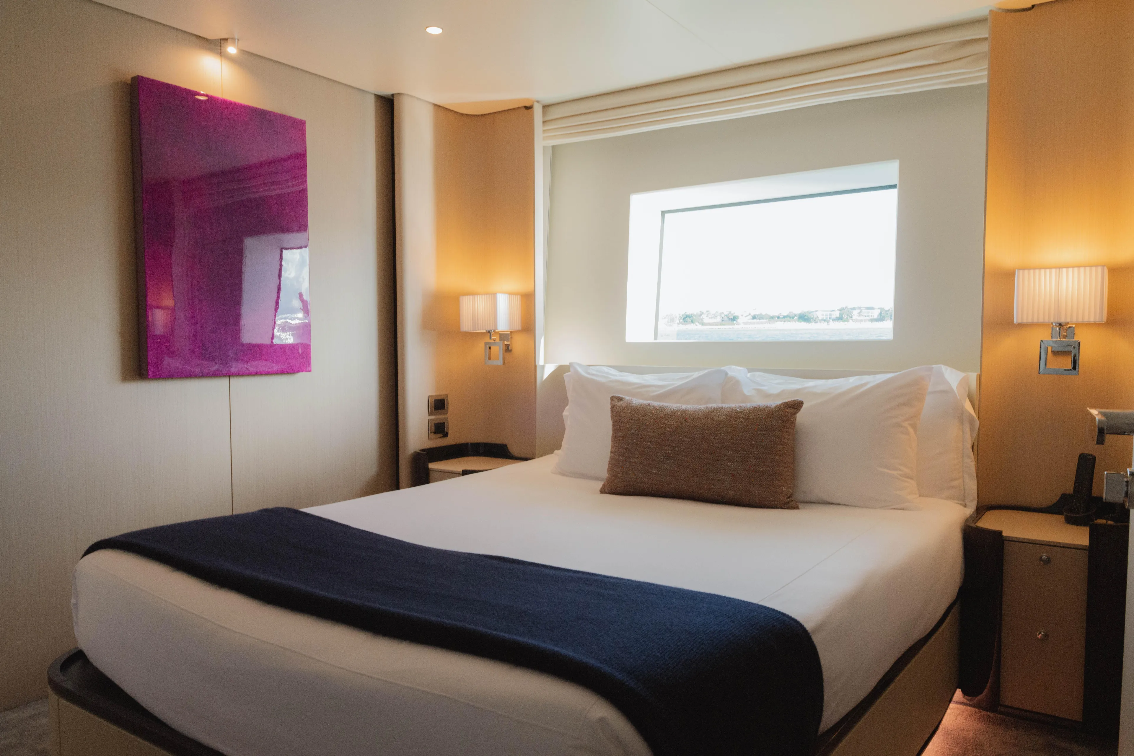 Carpe Diem Yacht Photos Pics Luxurious Azimut yacht bedroom, 2023 model, featuring elegant decor and a large window view.