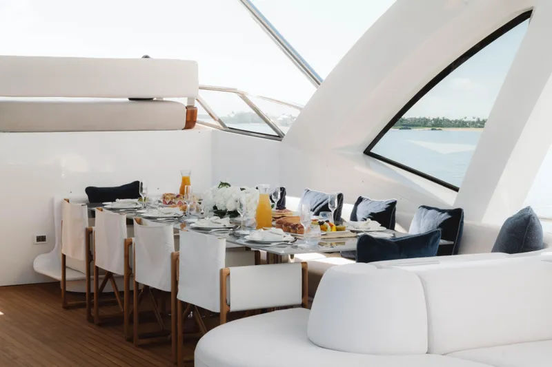 Carpe Diem Yacht Photos Pics Luxurious dining setup on a 2023 Azimut yacht with ocean view.